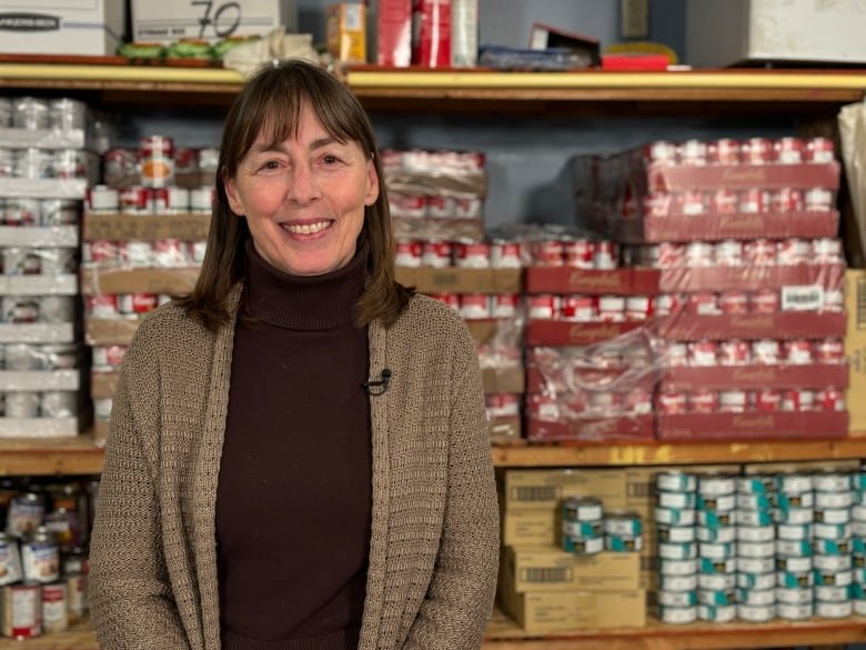 Cheryl Norgaard pictured in front of cans of soup