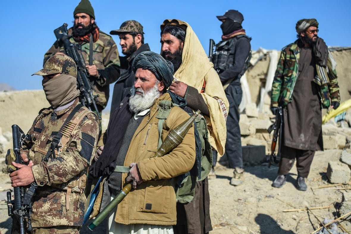 2190842343-1 Taliban security personnel stand guard at a site.