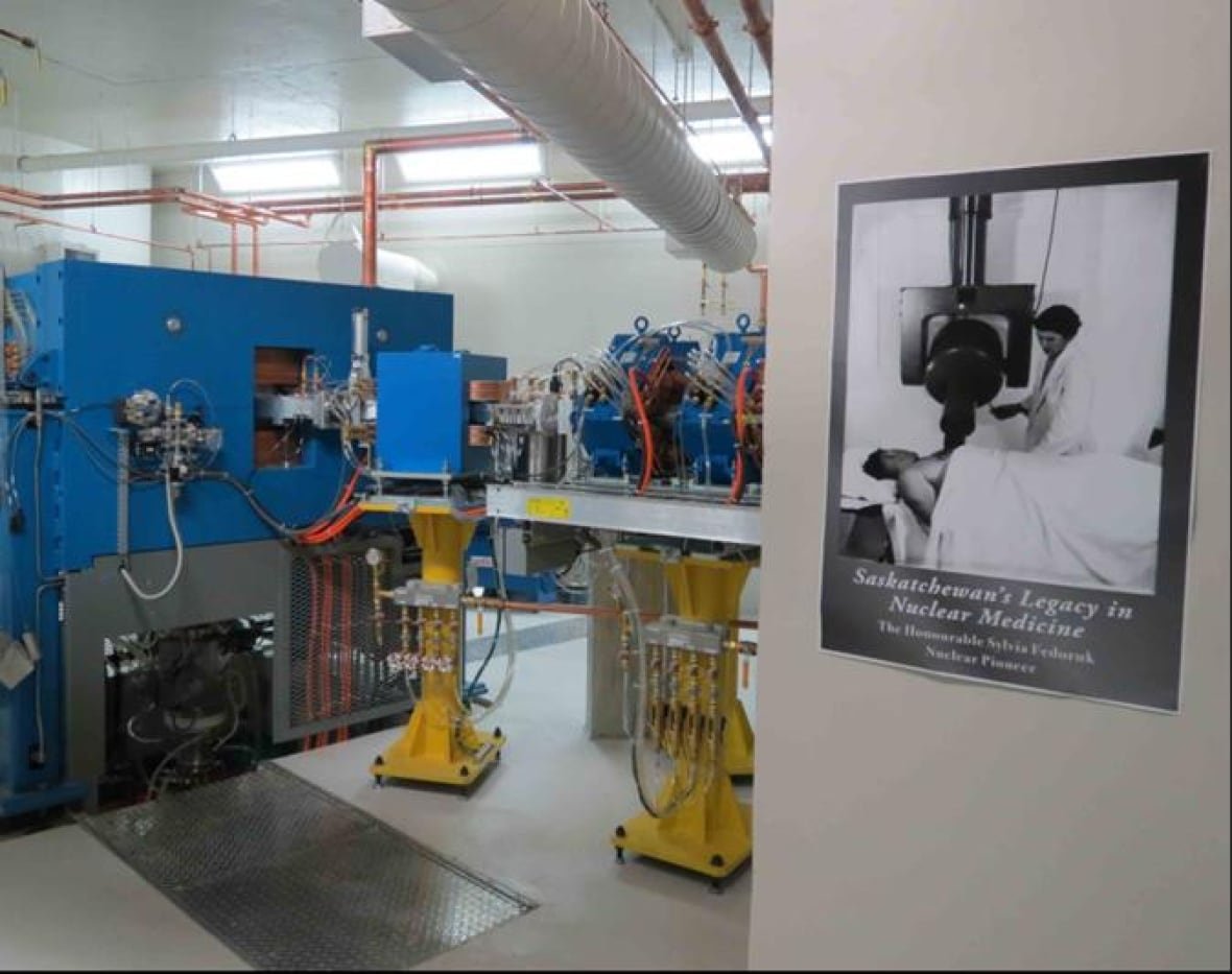 cyclotron-1 A large piece of equipment in a laboratory that is blue and yellow.