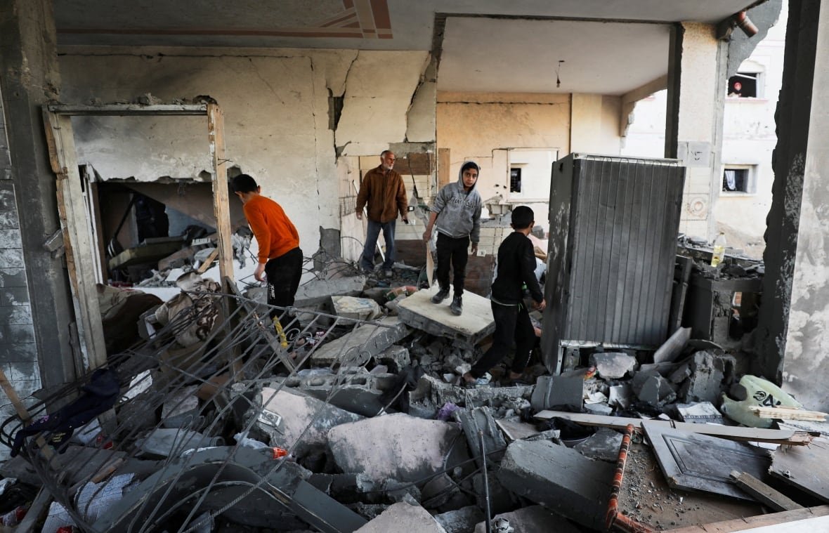 israel-palestinians-gaza-17 Palestinians inspect the site of an Israeli airstrike.