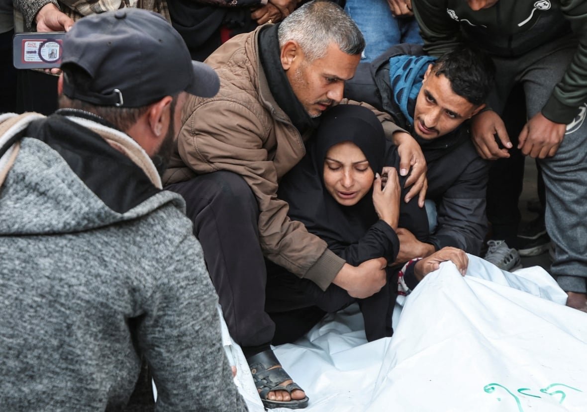 israel-palestinians-gaza-28 A woman is comforted as she mourns.