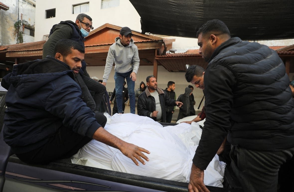 israel-palestinians-gaza-29 Mourners gather next to the bodies of Palestinians killed in Israeli airstrikes.