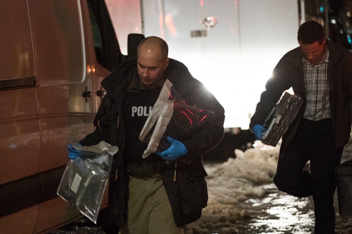 ont-kingston-arrest-20190124 Police officers carry evidence after raiding a house in Kingston, Ont. on Thursday Jan. 24, 2019