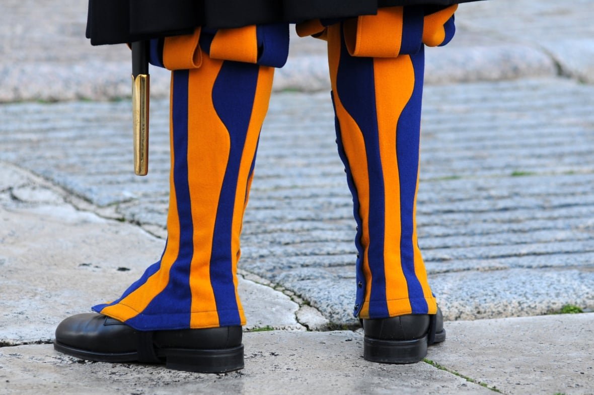 swiss-guards-6-1 A person's legs wearing striped yellow and blue coverings.