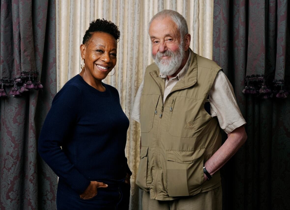 2024-tiff-hard-truths-portrait-session-1 A woman and older man smile at the camera.