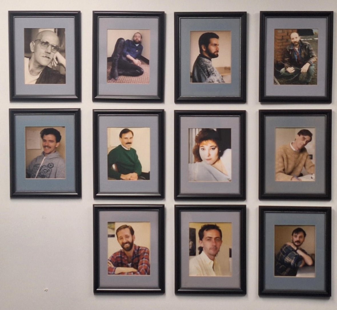 aids-coalition-wall Photographs on a wall, all of them portraits of people.