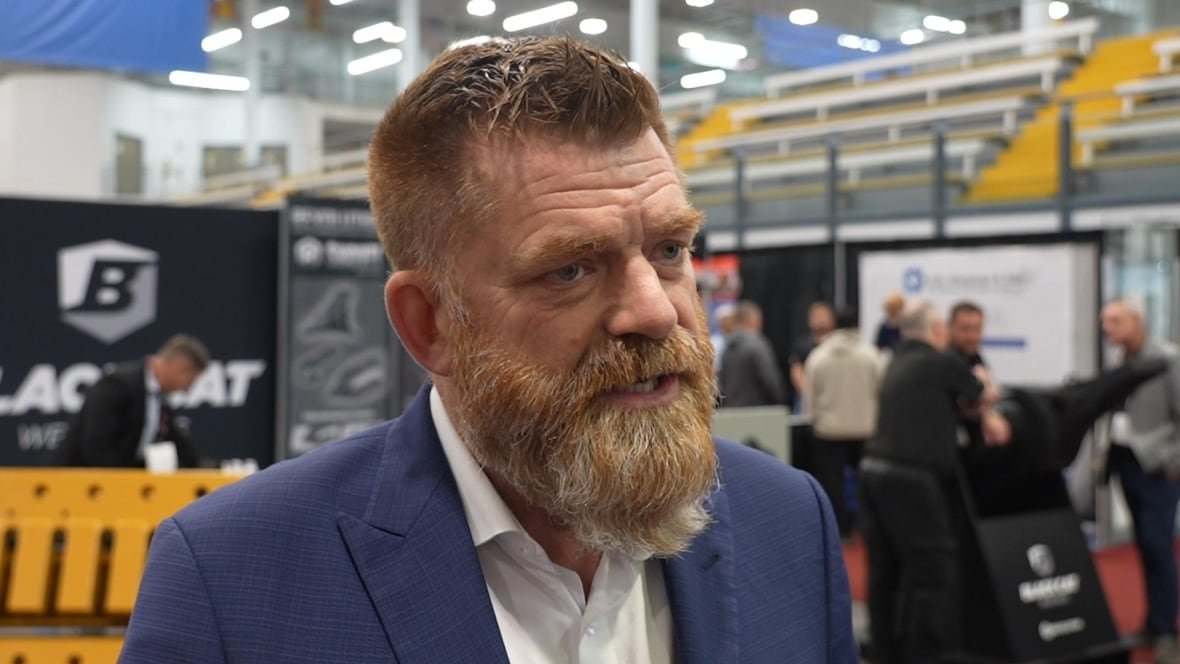 brian-jean Middle-aged man with big, red, greying beard, dressed in a suit.