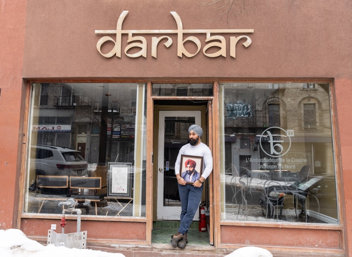 covid-anniversary-deaths-20250304-1 Simar Singh Anand, who calls himself a steward of legacy for his father Gurinder (Babu) Singh Anandm holds his father's photo at his restaurant in Montreal on Tuesday, March 4, 2025.