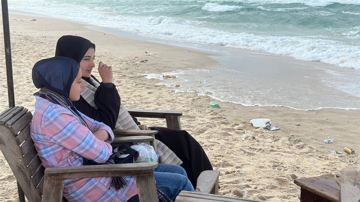 hanan-al-shennawi-1 Two women sit by the shore.