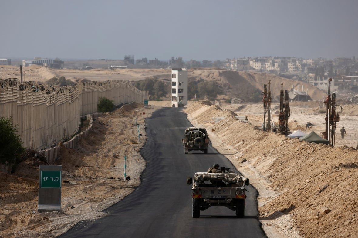 israel-palestinians-gaza-11 Military vehicles driving through a corridor in southern Gaza.