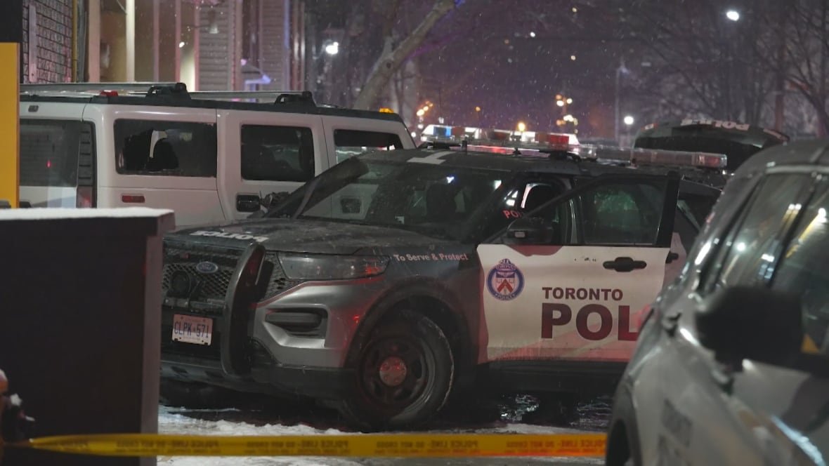 moss-park-hummer-and-police-vehicles-3 Police vehicles box in a Hummer on a Toronto city street at night. Light snow is falling in the background.