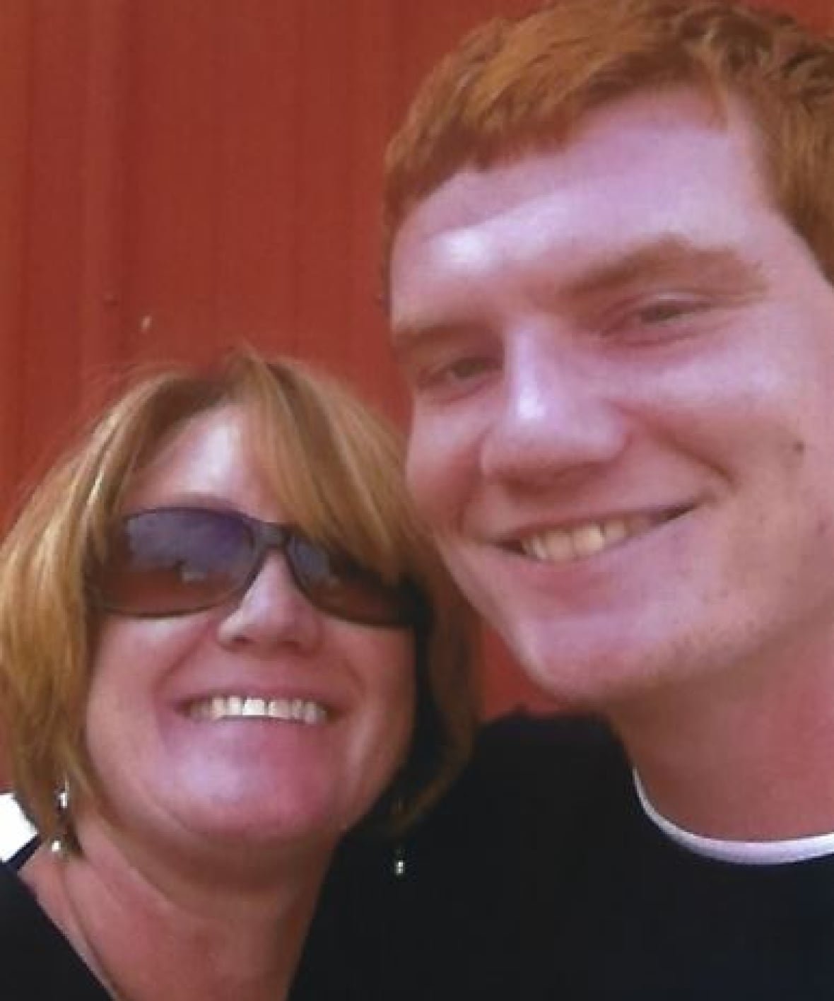 preventure-image-3 In a selfie-style photo, a woman poses with her 20-year-old son, she is wearing sunglasses and both are smiling at the camera.