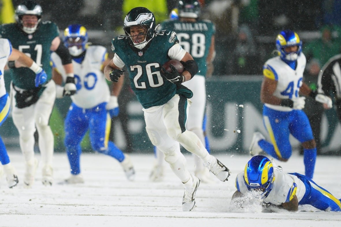 rams-eagles-football A football player runs with the ball.
