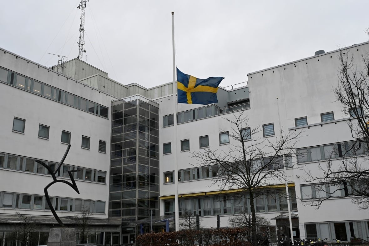 sweden-crime-7 A Swedish flag is flown at half-mast outside a building.