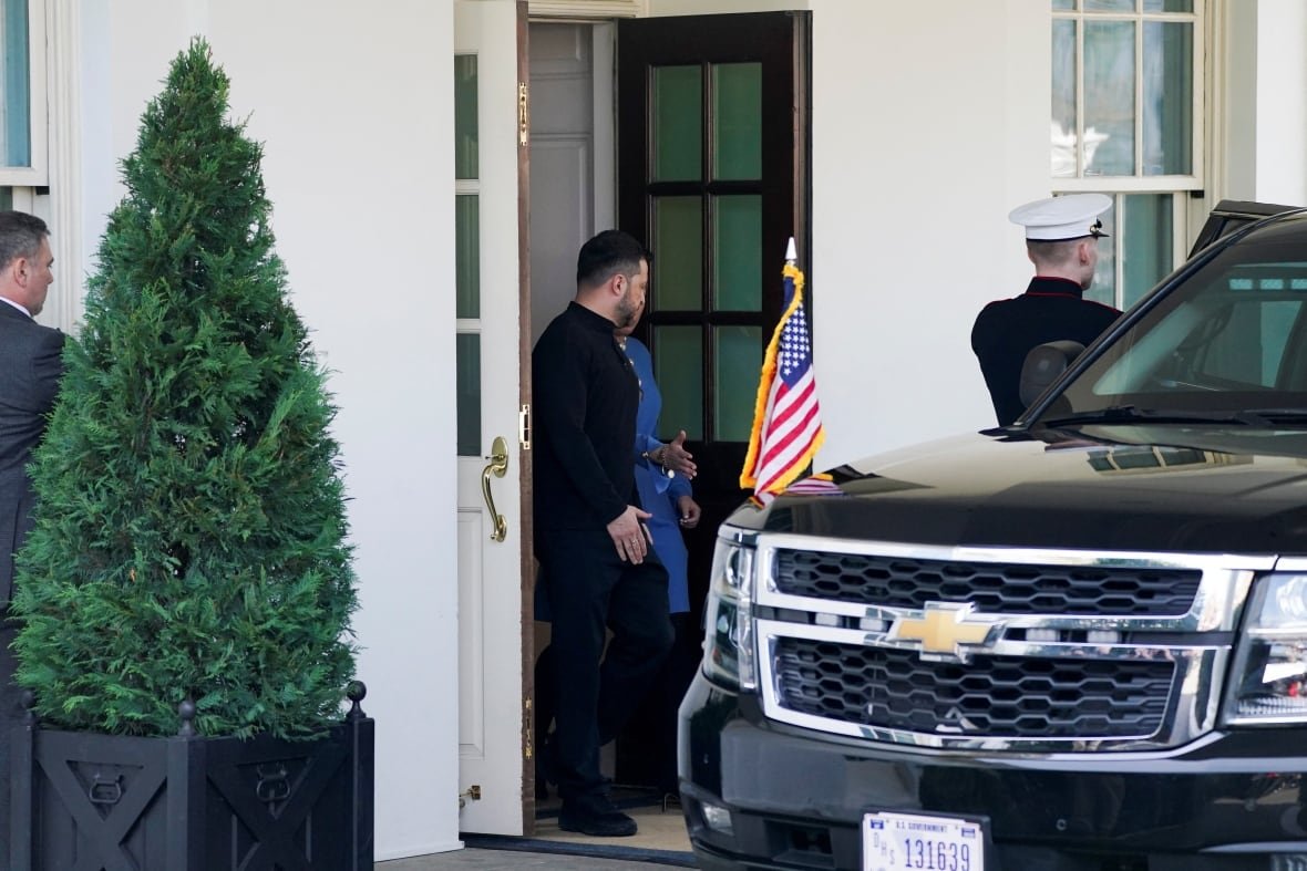 ukraine-crisis-usa-2 A man in formal black clothing leaves the White House and gets into a black SUV.