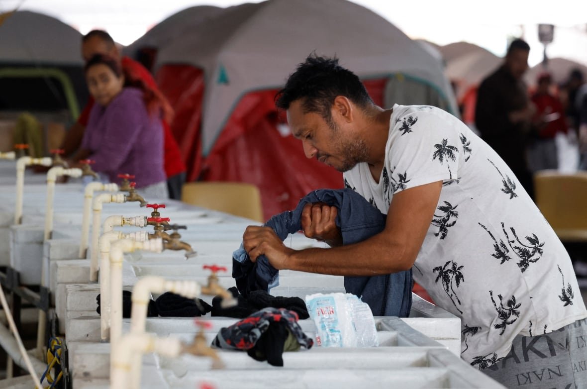 usa-trump-migration-mexico-3 A man washes his clothes in a temporary sink in Mexico, near the United States border.