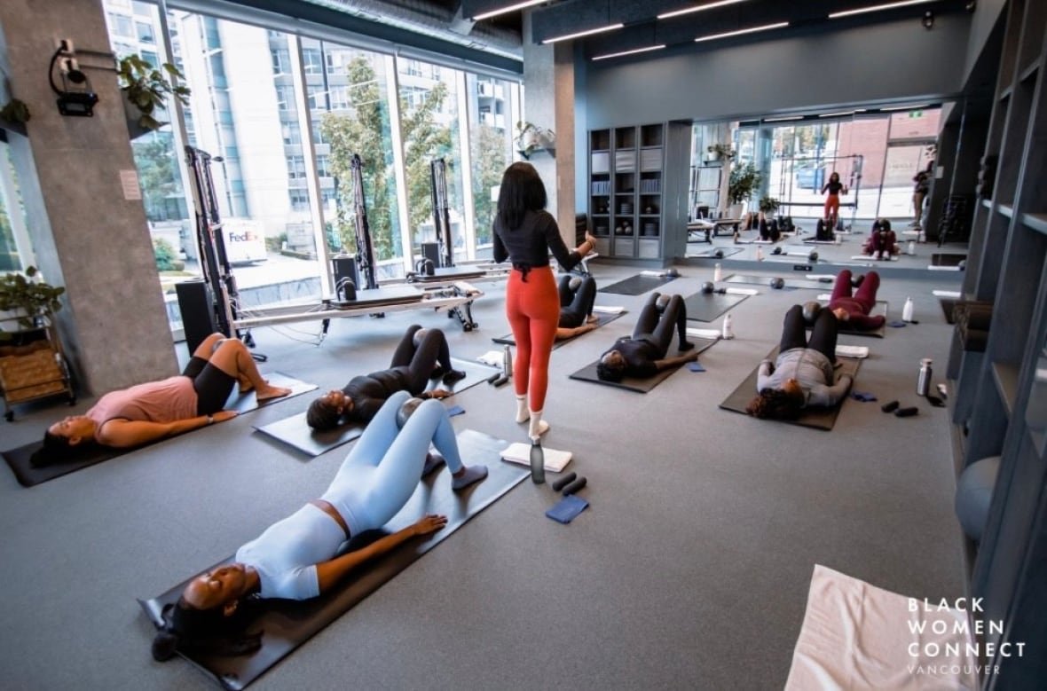 bwc Women lie on yoga mats at a yoga class.