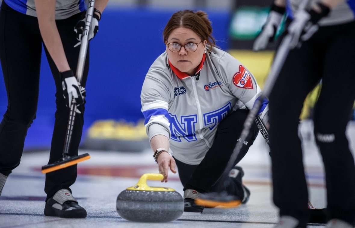 kerry-galusha A female curling skip makes a shot.