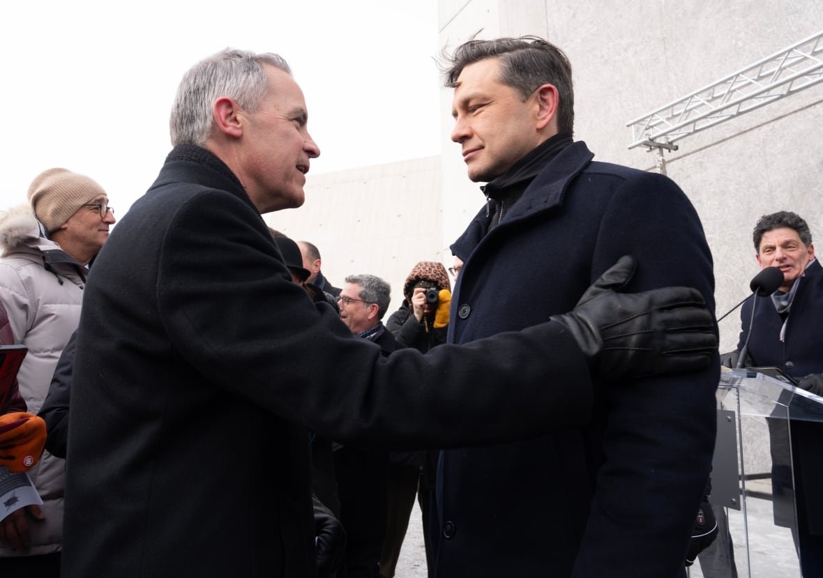 holocaust-commemoration-20250127 Liberal Leadership candidate Mark Carney speaks with Conservative Leader Pierre Poilievre before a ceremony at the National Holocaust Monument, Monday, Jan 27, 2025 in Ottawa.