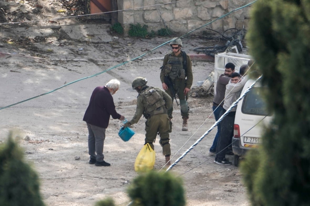israel-palestinians-4 A soldier checks an elderly man.