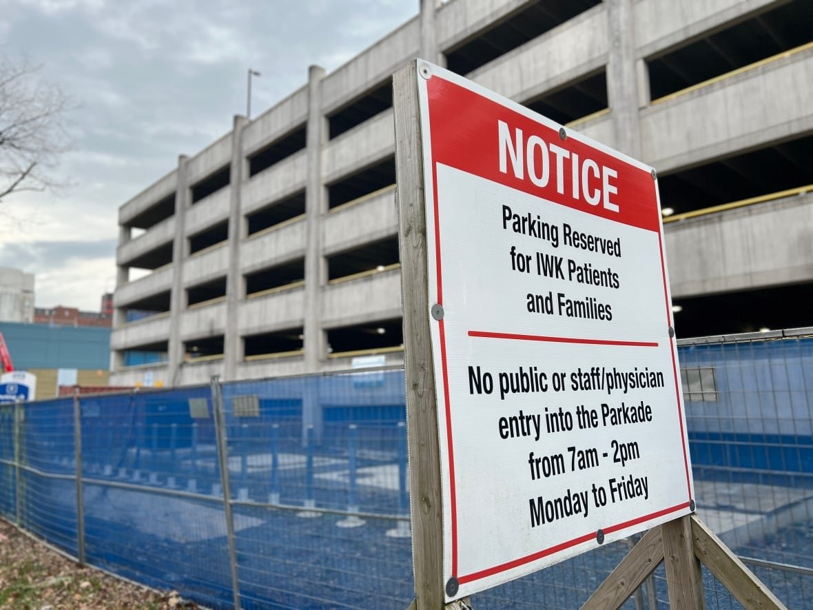 iwk-parking-2 A sign outside a parking garage says staff are not allowed to park there during specific hours during the week.