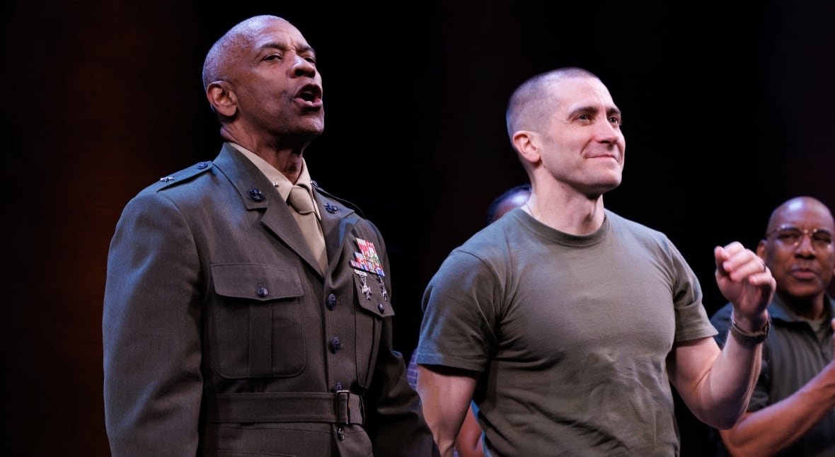 othello-broadway-opening-night-1 Two men stand next to each other. The one on the left side is wearing what appears to be a military uniform and is in the middle of calling or shouting. The second man is wearing a t-shirt and is smiling and pumping his fist.