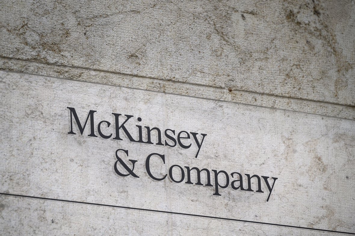 1239939775-1 A sign that says 'McKinsey & Company' in black on a grey background.