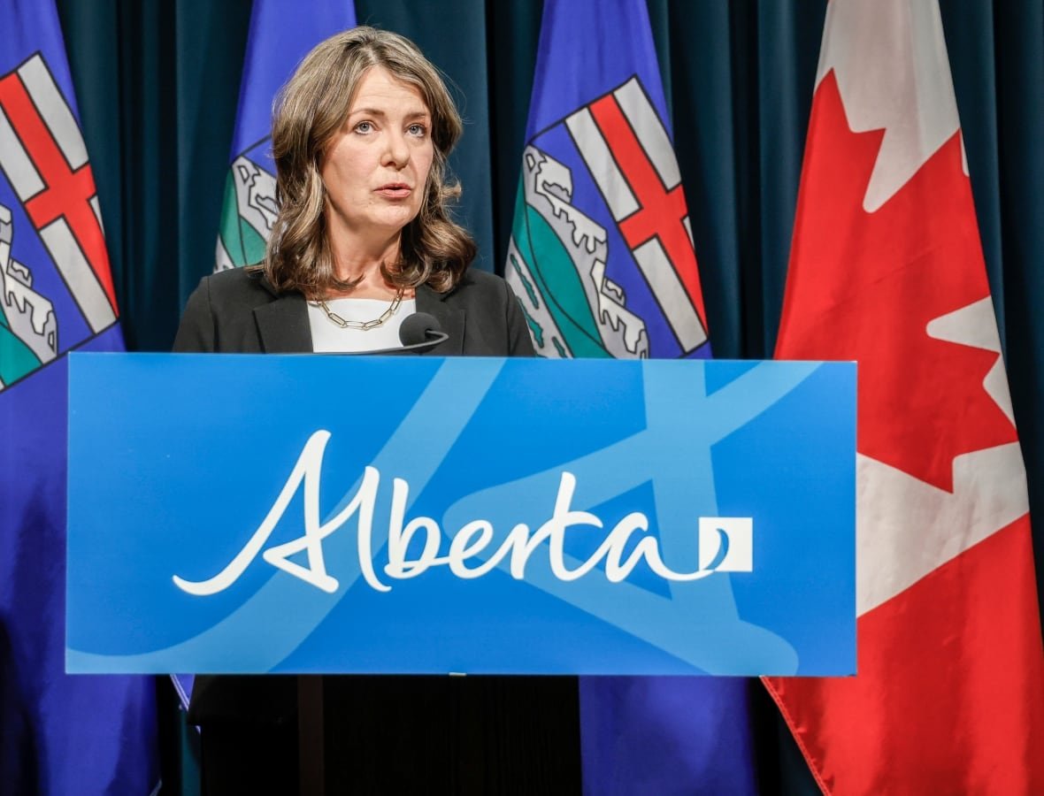 A woman stands behind a podium.