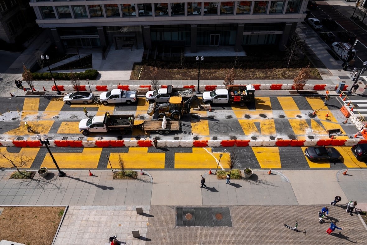 black-lives-matter-trump-1 A man in a U.S.A.-themed blazer and red pants takes a cell phone photo at bottom right, as demolition begins on the Black Lives Matter mural, seen from above, Monday, March 10, 2025, in Washington. (AP Photo/Jacquelyn Martin)