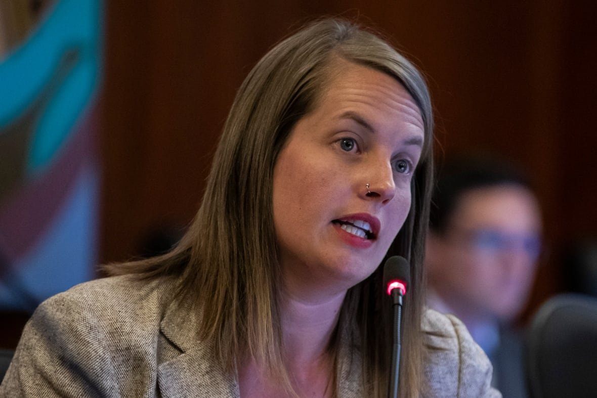 city-of-vancouver-council-1 A brown-haired woman with a nose piercing speaks into a mic at council chambers.
