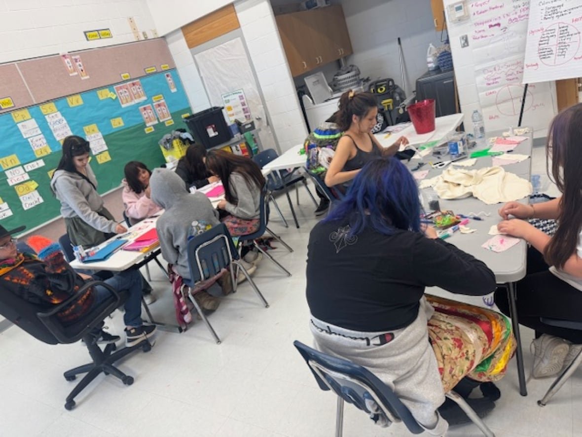 creating-medicine-bags A photo of girls sitting at tables and making medicine bags