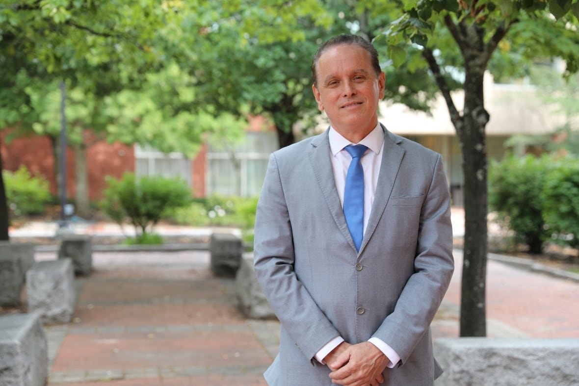 dr-alier-marrero-neurologist-new-brunswick-1 a man stands up wearing a suit.