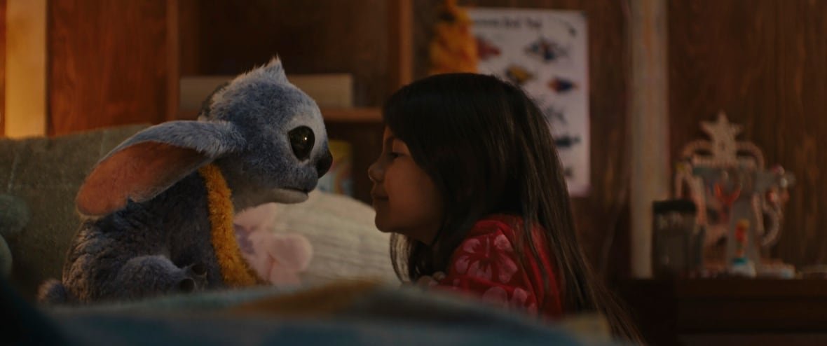 ent-film-review-lilo-stitch-3 A little girl and blue alien look at one another.