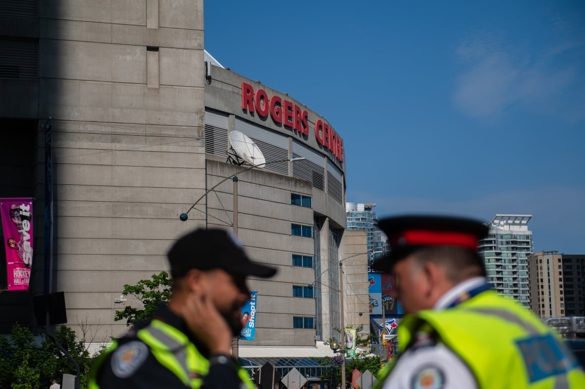 music-kendrick-lamar-20250612-3 Toronto Police officers stand outside of a Kendrick Lamar concert at Rogers Centre