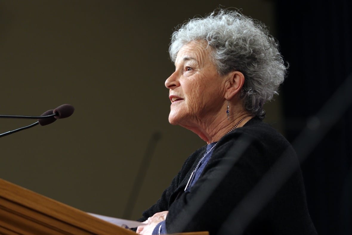 overdose-crisis-20190214-1 A woman with white, curly hair speaks into a mic at a podium.