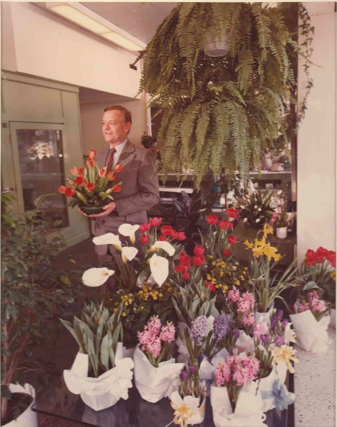 paul-chandler A retro-looking colour photograph of Paul Chandler, Michael Murray's uncle, holding a flower inside Scrim's florist.