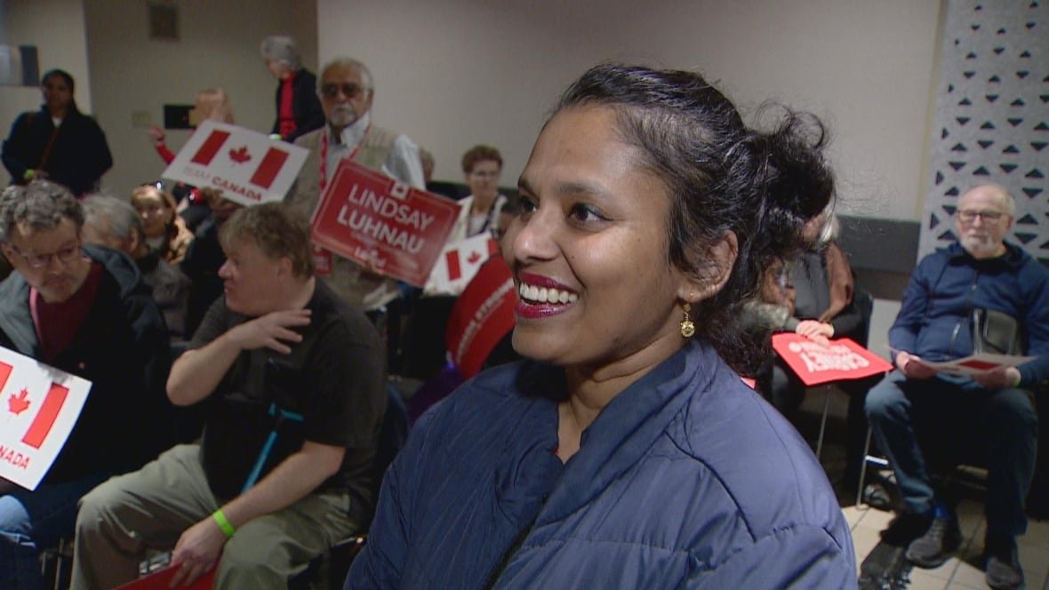 A woman smiles for the camera.