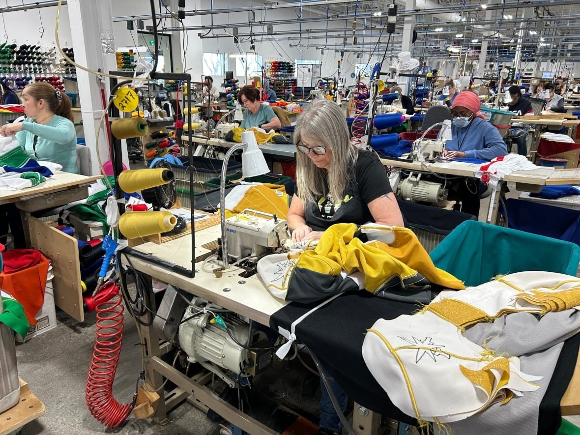 Workers in a factory make hockey jerseys