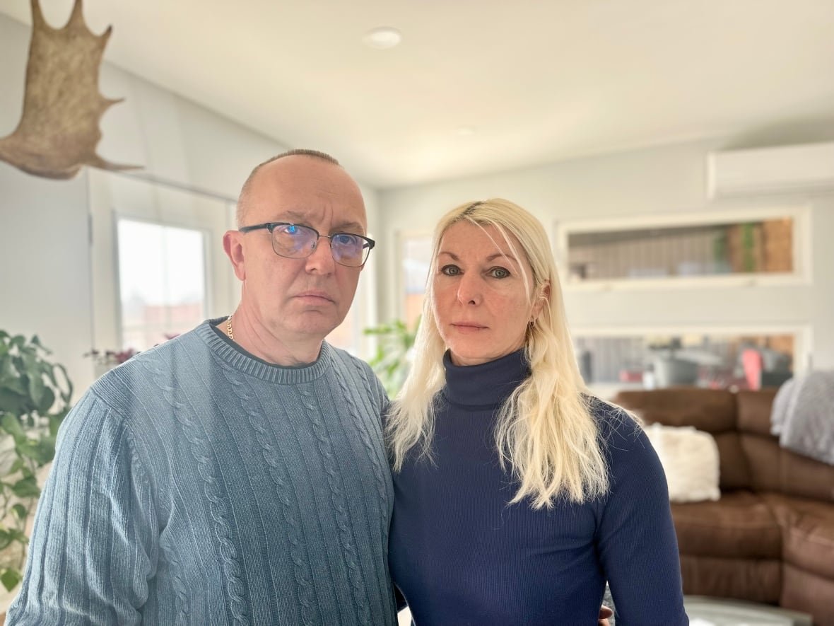 woman and man stand in living room