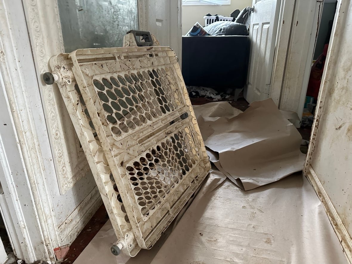 a hallway with a baby gate turned brown