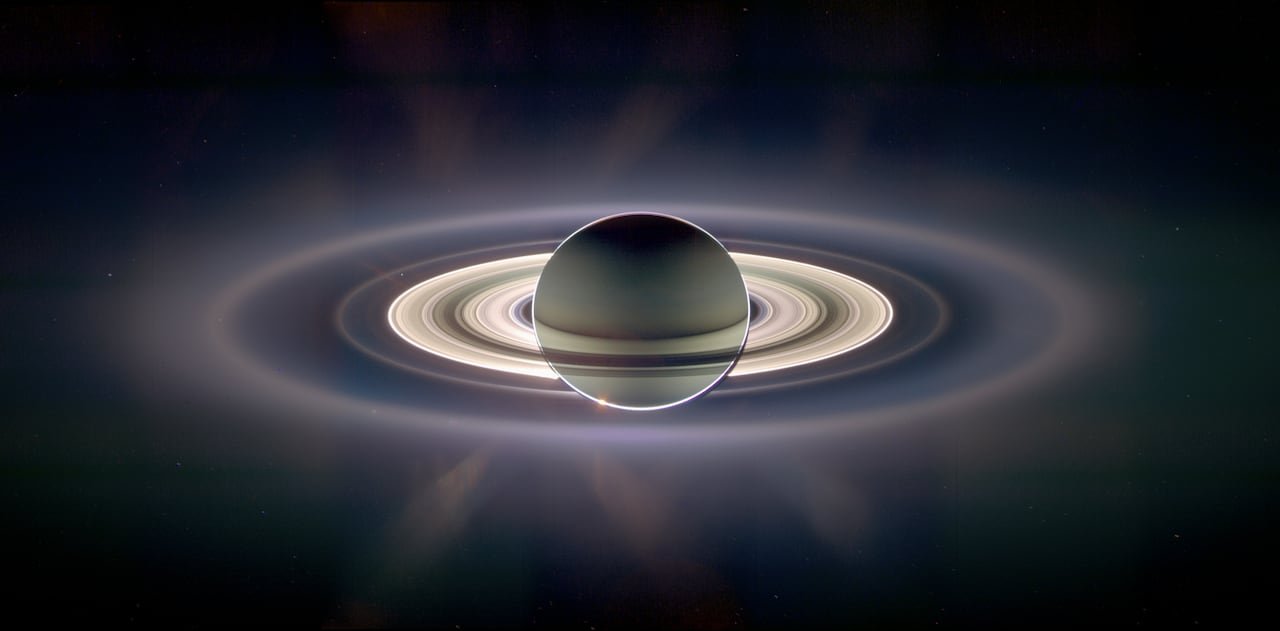 Rings surround a planet hanging in space.