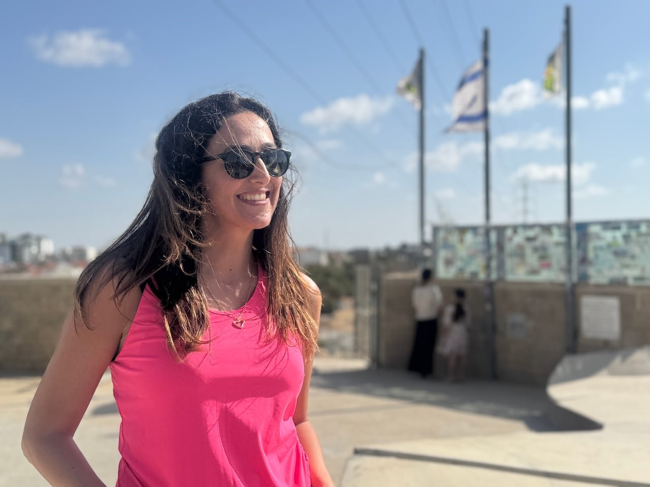 A person smiling at a lookout point.