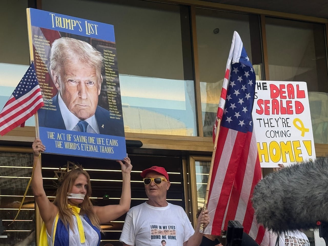 Demonstrators with signs and flags.