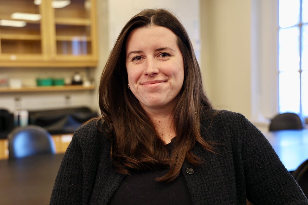 A woman stands in a university laboratory.
