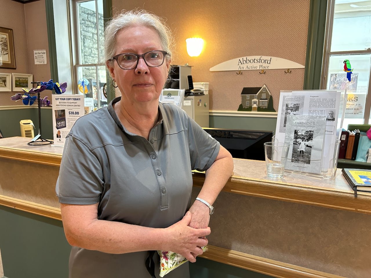 default-395 A woman stands at a desk.