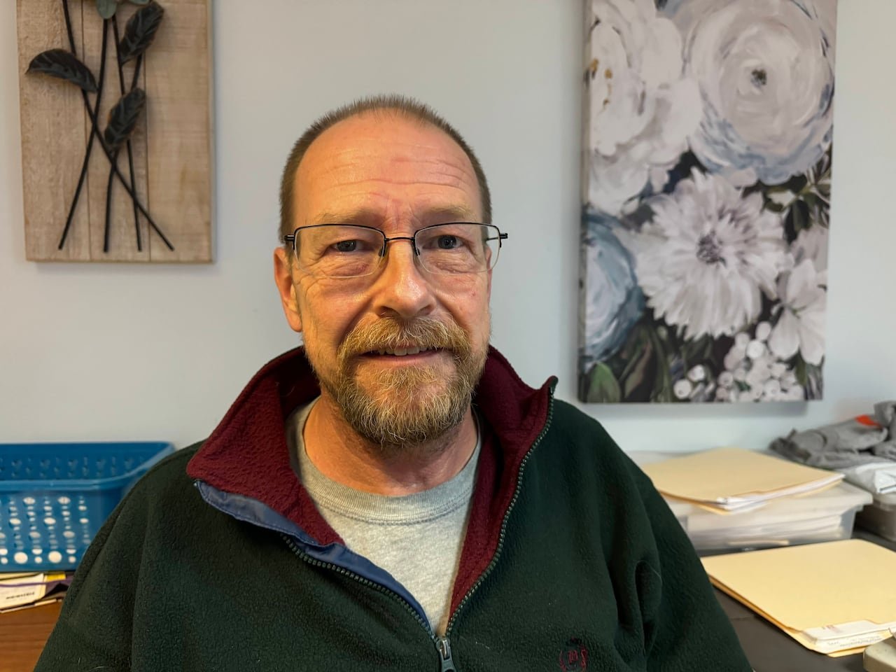 A bearded man with glasses.