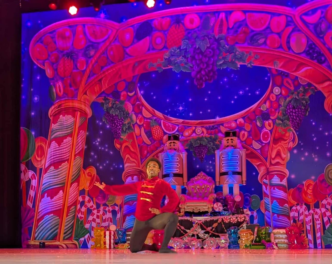 Male ballet dancer doing pose in front of The Nutcracker set