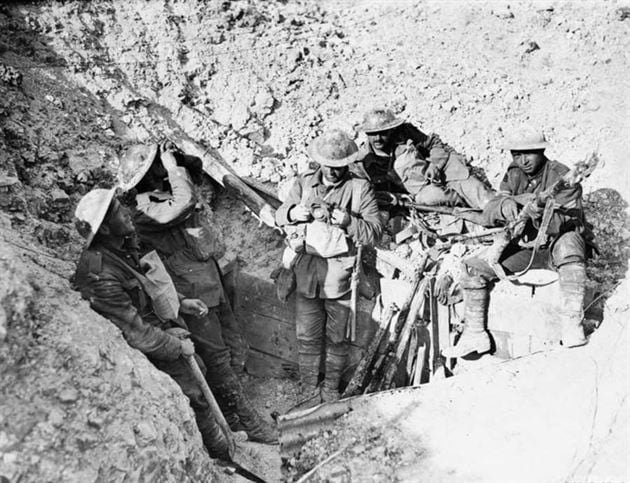 Black and white photo of Canadian soldiers resting in a bunker.