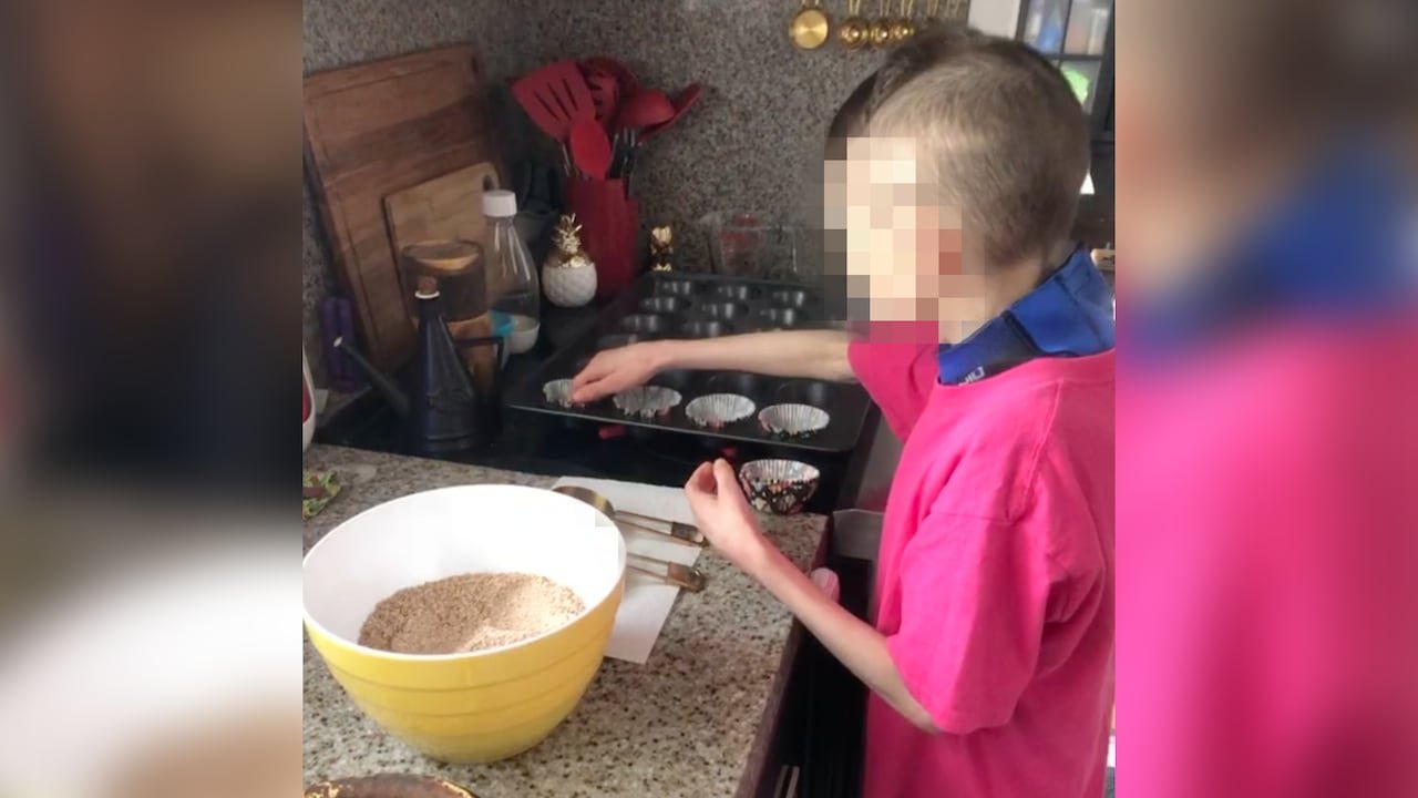 two thin boys standing at a counter