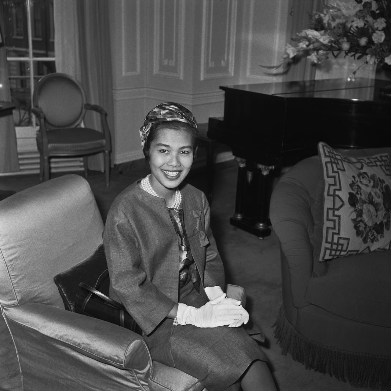 default-3193 A person sits and smiles while posing for a photograph in this black and white image.